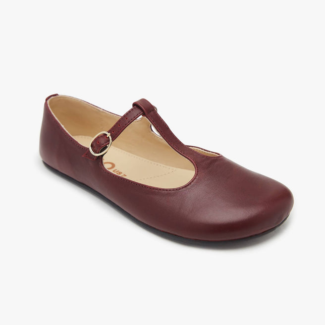 The Women's T Strap Color barefoot flat Wine in a white background 1