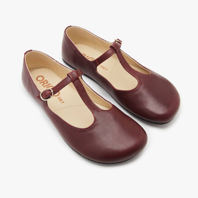 The Women's T Strap Color barefoot flat Wine in a white background 2