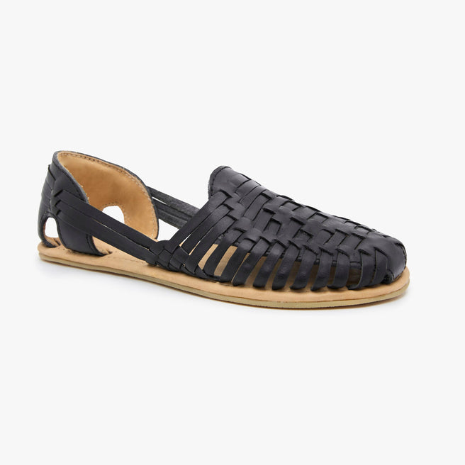 Black woven leather Huarache Slip-On by Anya, angled three-quarter view of a single shoe with tan sole.