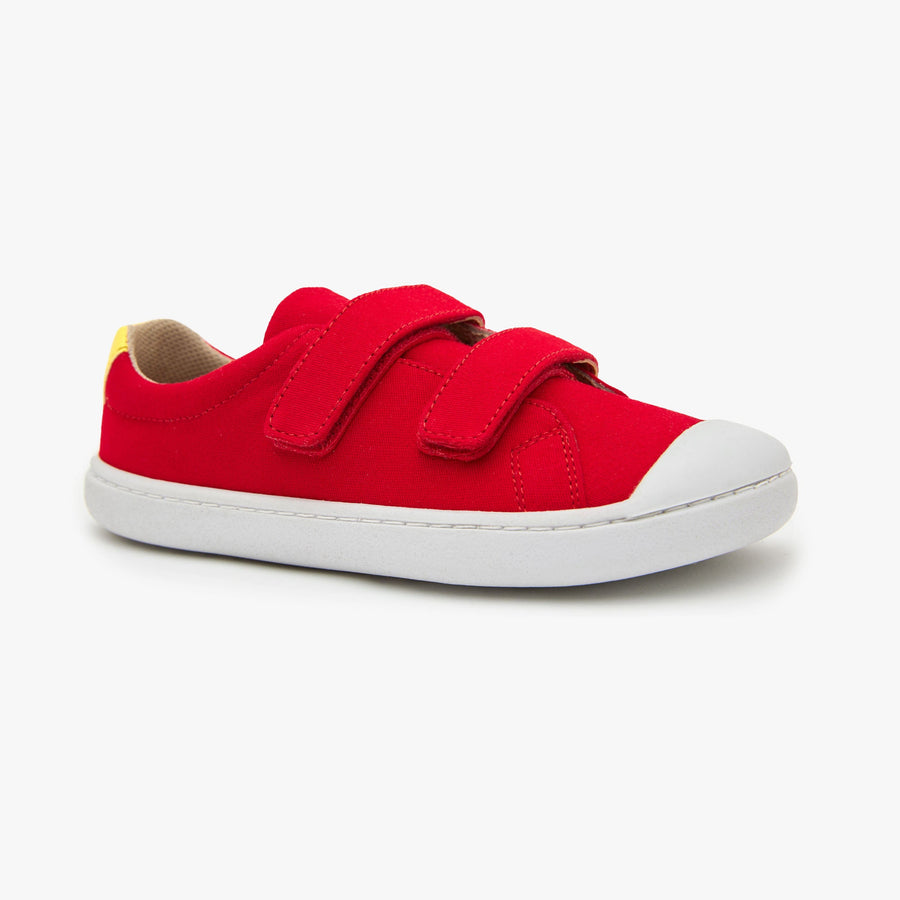 Red cotton canvas Kid's Hook & Loop sneaker by Origo with two straps and white sole, angled side view.