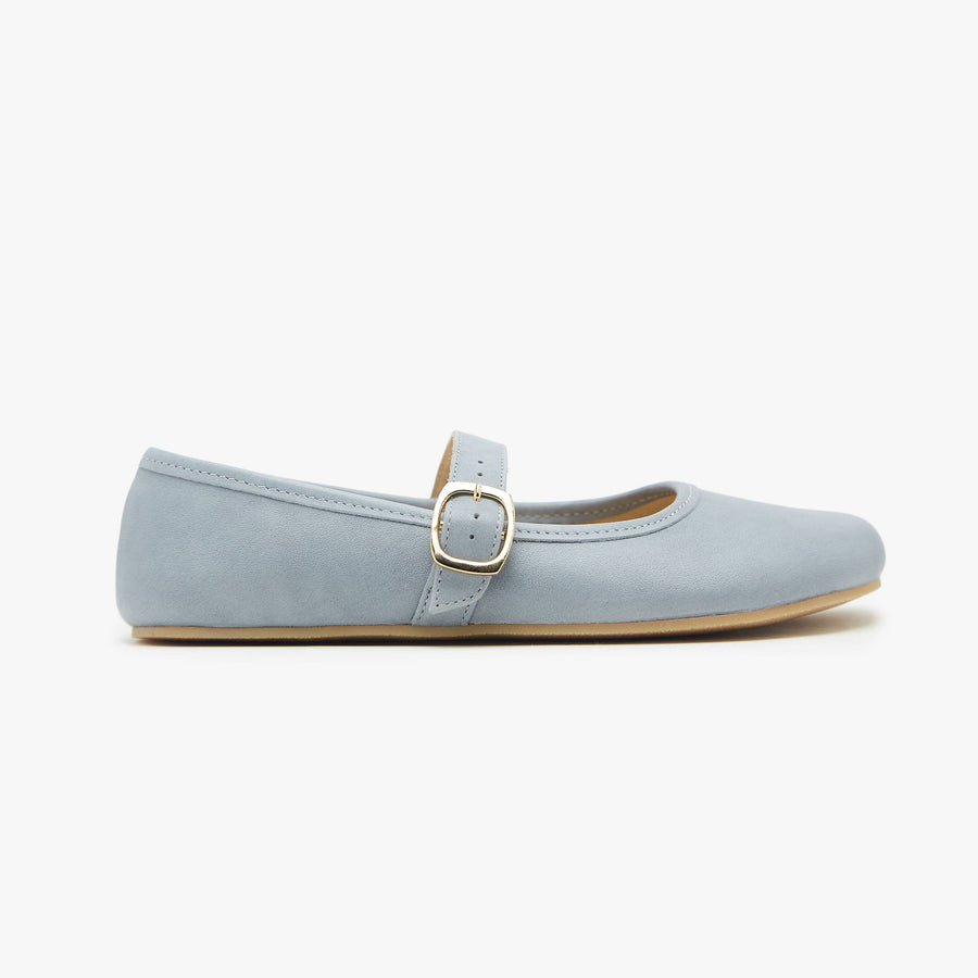 Light blue flat shoe with a gold buckle on a white background