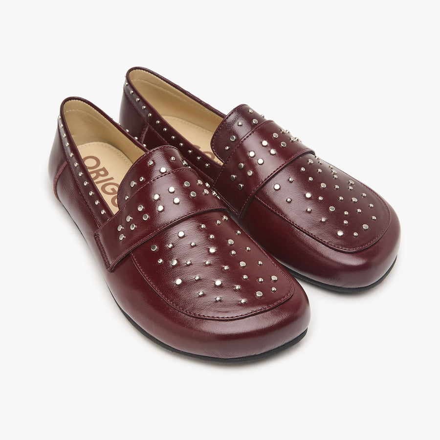 Origo Women's Penny Loafer, Studded Patent Burgundy - three-quarter view of the pair